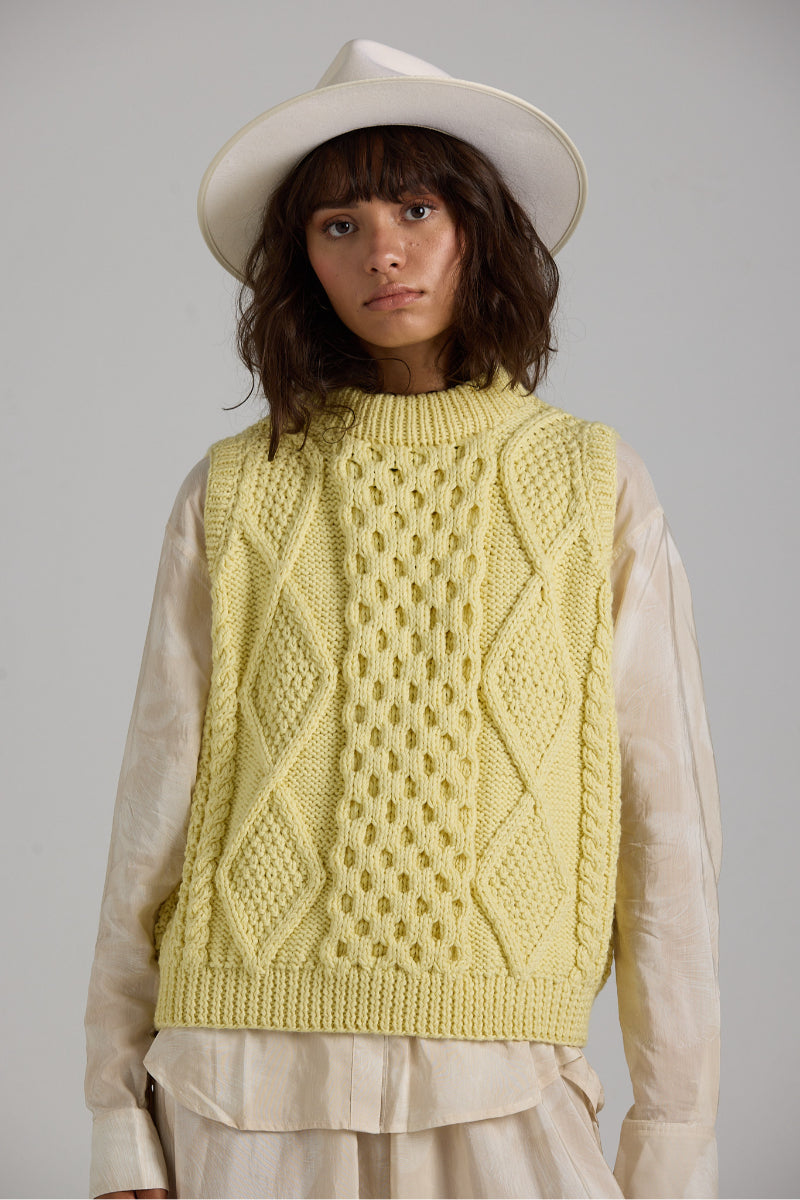 Gray Tierra Vest knitwear by First Born Knits featuring a cozy, textured design and ribbed neckline on a mannequin.