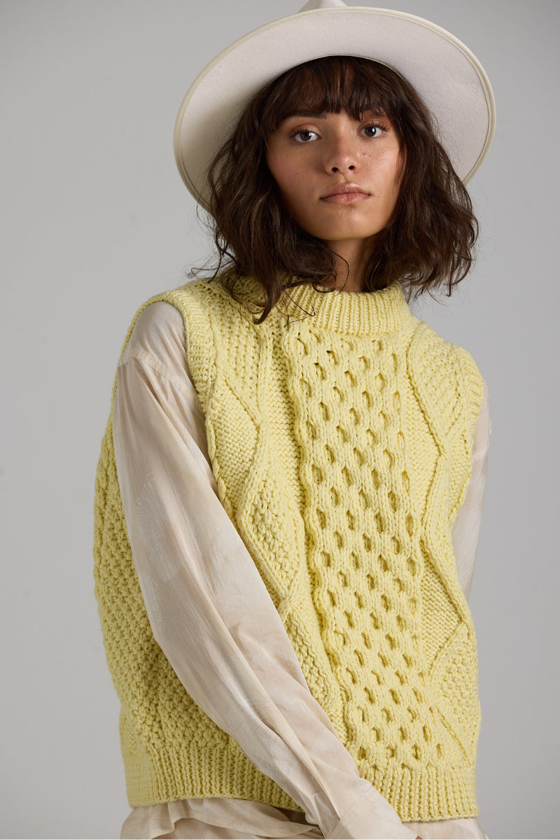 Cream-colored Tierra Vest knitwear by First Born Knits, featuring a cozy, textured design and a fitted silhouette.