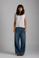 White Chloe vest from First Born Knits, a stylish knitted top featuring a classic design and soft fabric details.