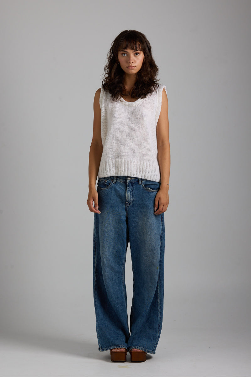 White Chloe vest from First Born Knits, a stylish knitted top featuring a classic design and soft fabric details.