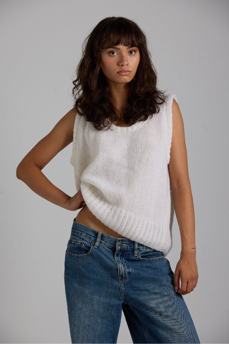 White Chloe vest from First Born Knits, a stylish knit top featuring a cozy, fitted design perfect for layered looks.