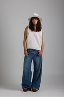 White Chloe knit vest from First Born Knits, styled as a trendy tops piece, featuring soft fabric and a classic fit.
