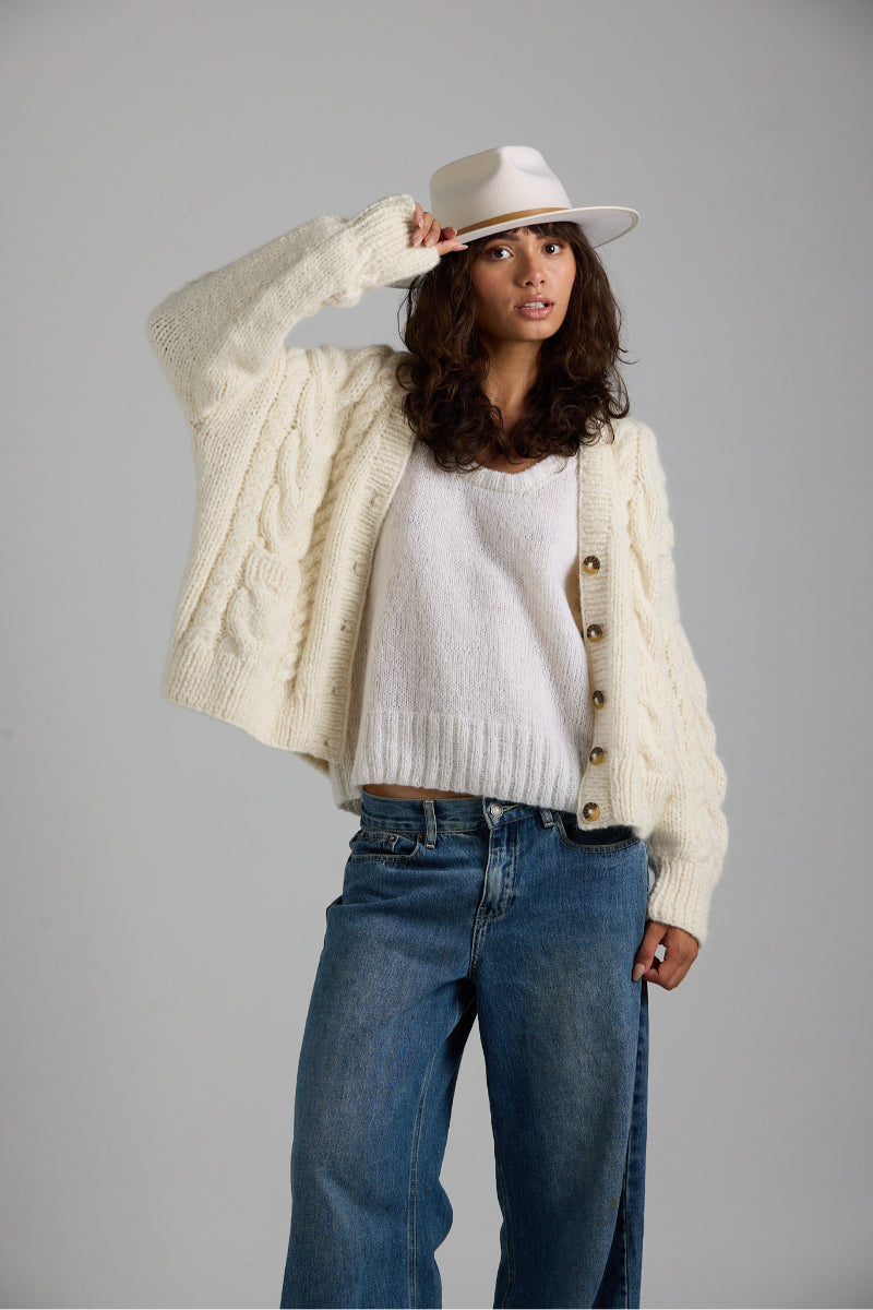White Chloe vest by First Born Knits, casual knit top with a fitted silhouette, displayed on a neutral background.