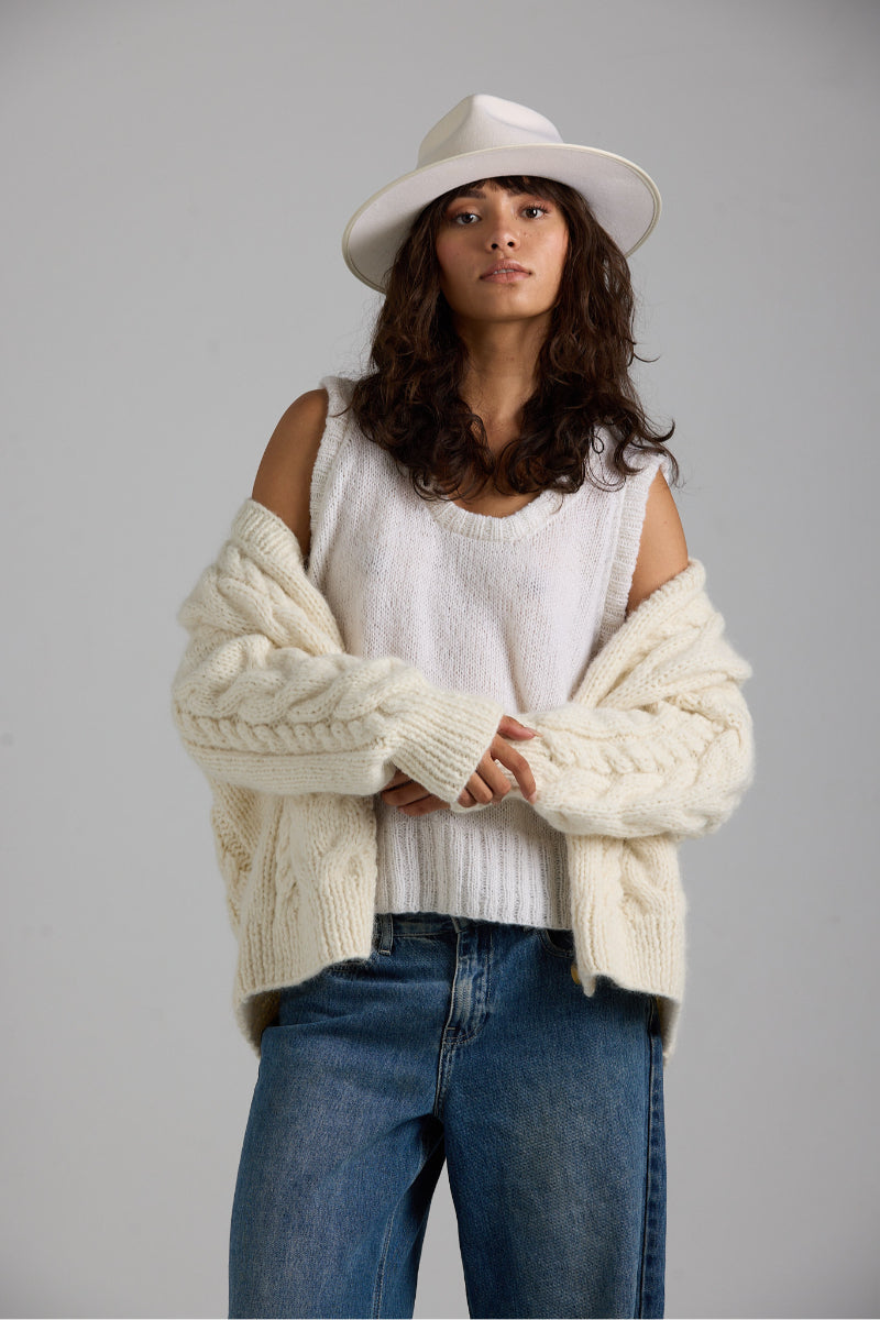 White Chloe vest from First Born Knits, a stylish knit top with a cozy, textured design, perfect for layered casual wear.