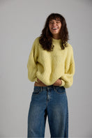 Cream-colored Shell Sweater by First Born Knits, featuring a cozy knitted design and relaxed fit.