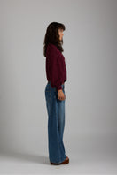 Soft beige Frenchie cardigan by First Born Knits, featuring a cozy knit texture and button closure.