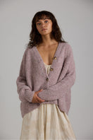 Purple Coco cardigan from First Born Knits, soft knitwear with a relaxed fit, shown on a model.