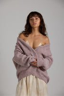 Purple Coco cardigan by First Born Knits, featuring a cozy knit texture and button-up front, perfect for layered outfits.