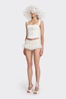 Off-white fitted corset bustier by Stolen Stores, showcasing a structured top with lace-up front and boning details.