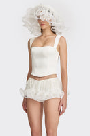 Off-white fitted corset bustier top by Stolen Stores, showcasing a sleek, structured design with adjustable straps and boning details.