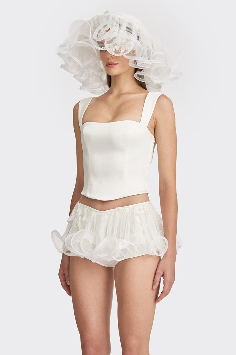 Off-white fitted corset bustier top by Stolen Stores, showcasing a sleek, structured design with adjustable straps and boning details.