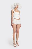 Off-white fitted corset bustier top by Stolen Stores, showcasing the structured design and sleek fit on a mannequin.