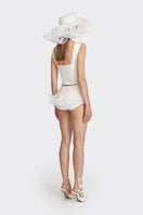 Off-white fitted corset bustier top by Stolen Stores, shown on a model, with structured design and adjustable straps.