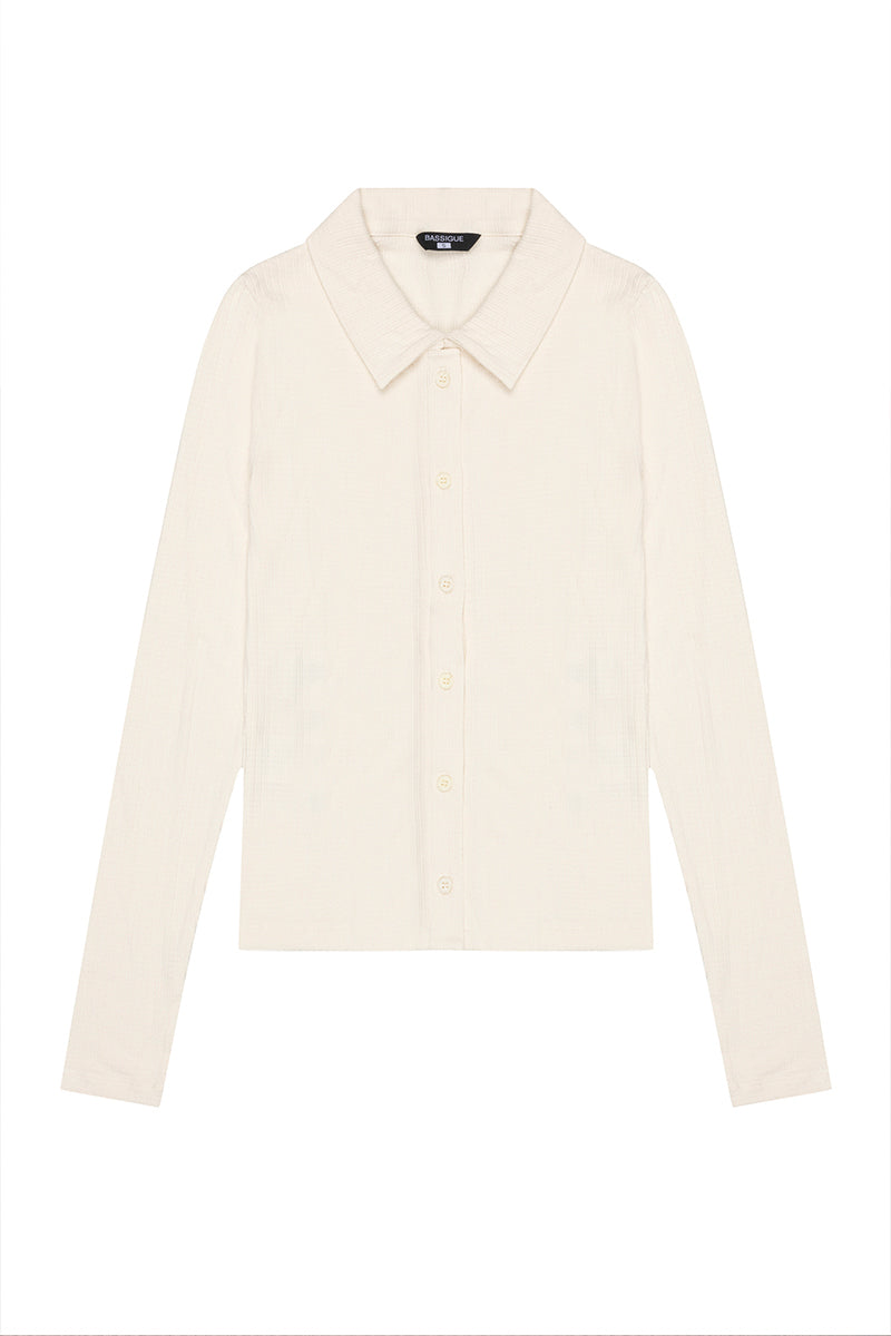 White fitted rib button-down shirt by Bassigue, showing the tailored collar and ribbed fabric detail.