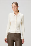 White fitted ribbed button-down shirt by Bassigue, close-up of the tailored collar and front buttons.