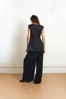 Black fixed corset top by Yassmin Saleh, showing the back design with structured fit and adjustable straps.