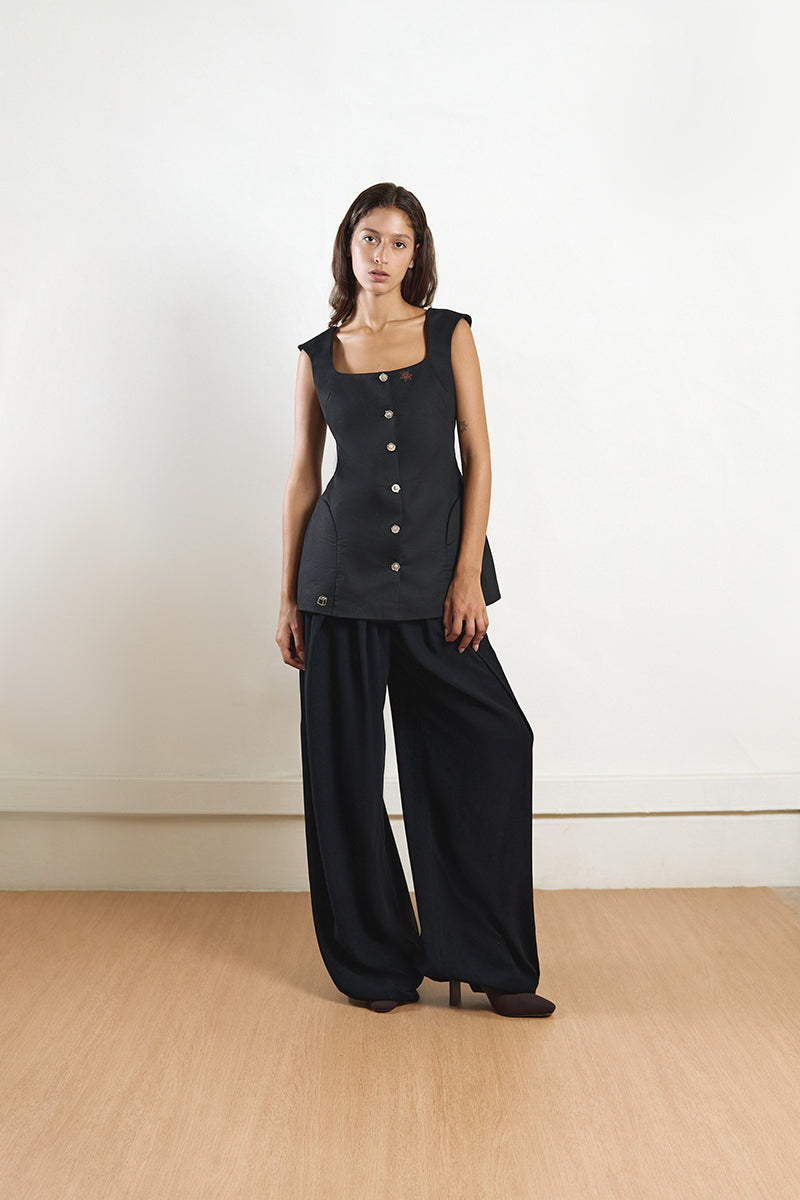 Black fixed corset top by YASSMIN SALEH featuring structured design and front fastening, displayed from the front view.