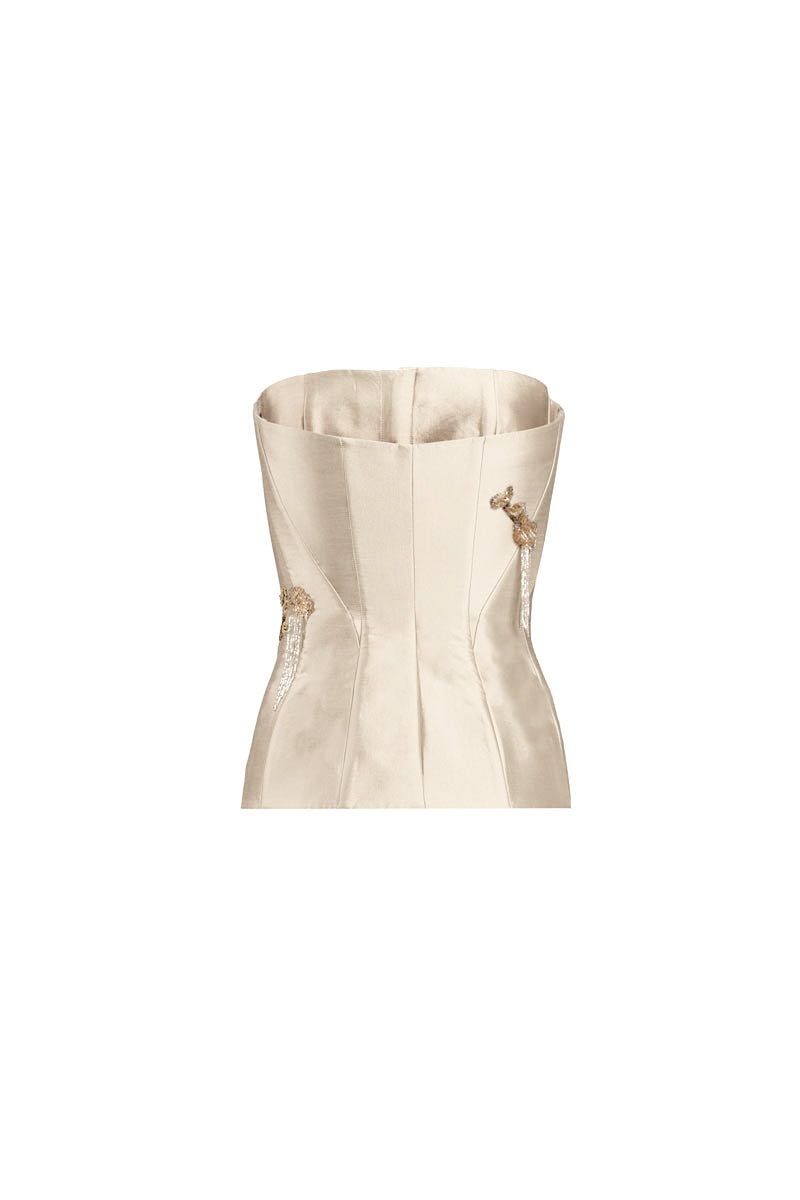 White flare corset top by YASSMIN SALEH featuring a fitted design and stylish flare details, shown from the back.