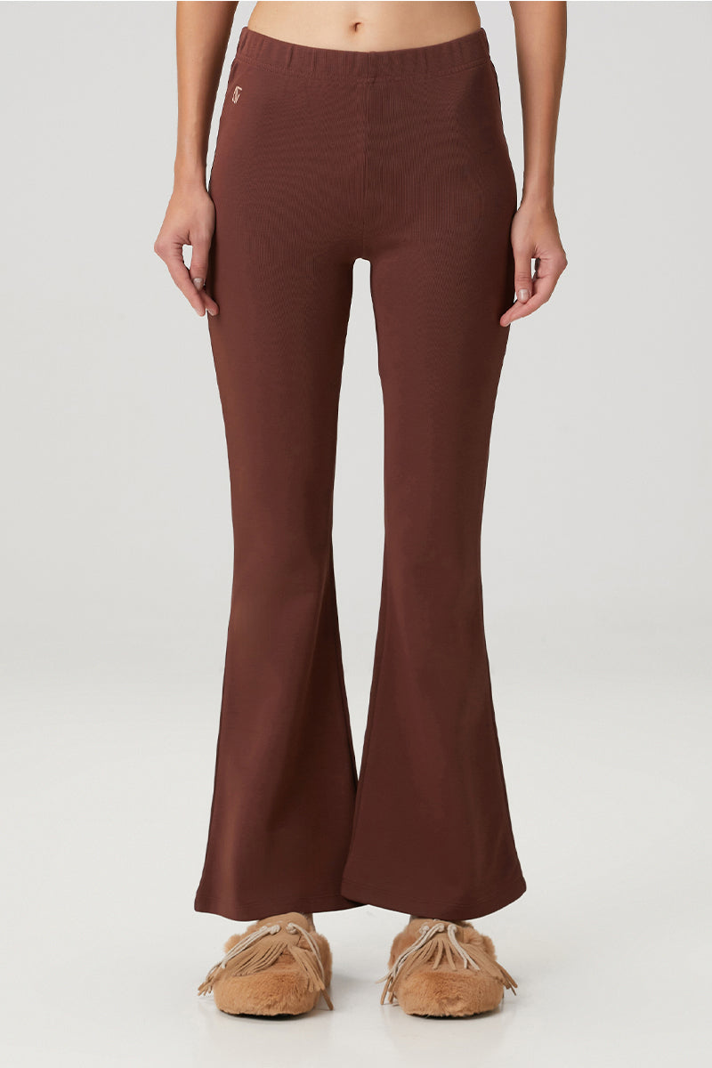 Brown flare sweatpants by Bassigue featuring a relaxed fit and comfortable waistband, styled for casual wear.