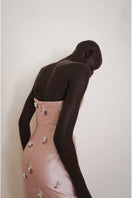 Close-up of the pink Flicker Gown by Yassmin Saleh, showing detailed back design and elegant fabric texture.
