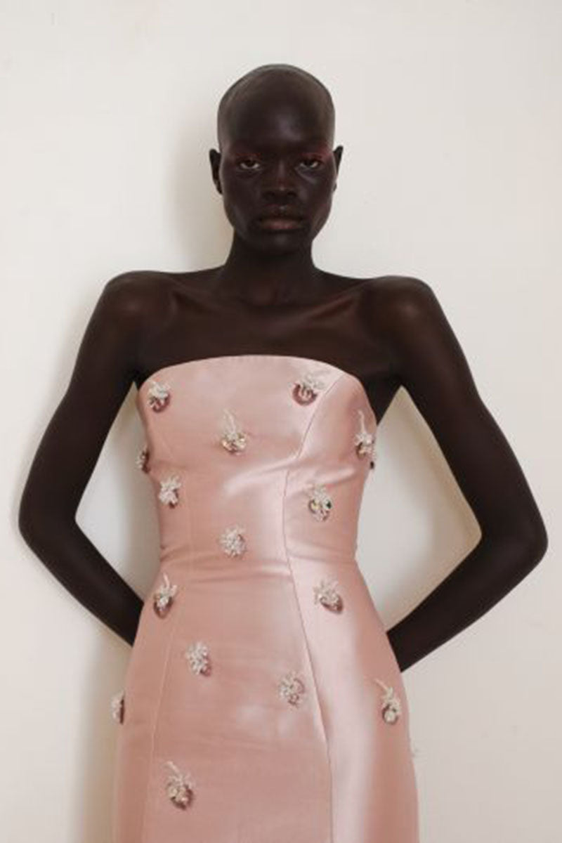 Close-up of YASSMIN SALEH Flicker pink gown showcasing elegant fabric and detailed design.