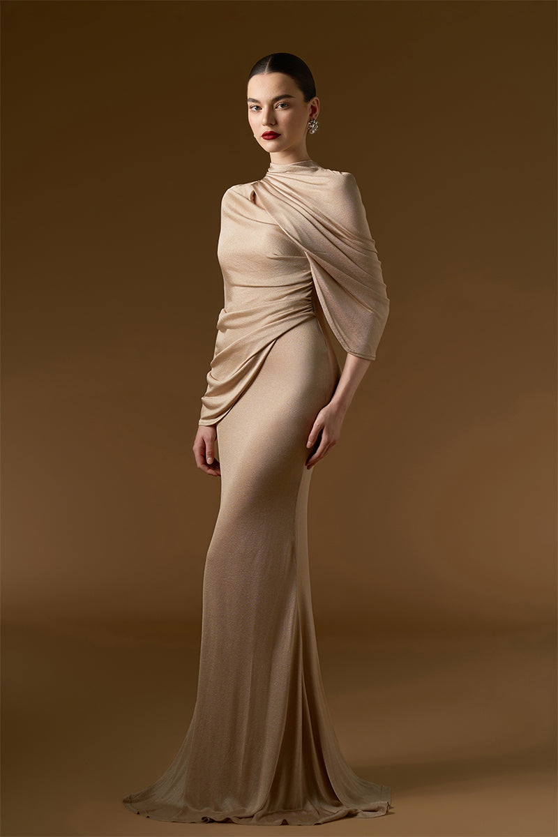 I.H.F Bonnie shimmer jersey gown in beige, floor-length mermaid style with cascading shoulder drape and elegant silhouette.