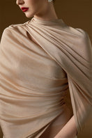 I.H.F Bonnie Shimmer Jersey Gown in beige, floor-length mermaid style with cascading shoulder drape and elegant shimmer fabric.