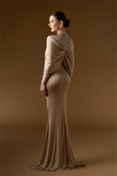 I.H.F Bonnie Shimmer Jersey Gown in beige, floor-length mermaid style with cascading shoulder drape, elegant evening gown.