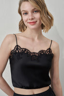 Black Flora Lace Silk Camisole Top by MANITO, featuring delicate lace details and a smooth silky fabric, shown on a model.