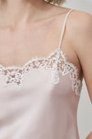 Pink silk camisole top with lace details from MANITO's Flora Lace collection, shown on a hanger.