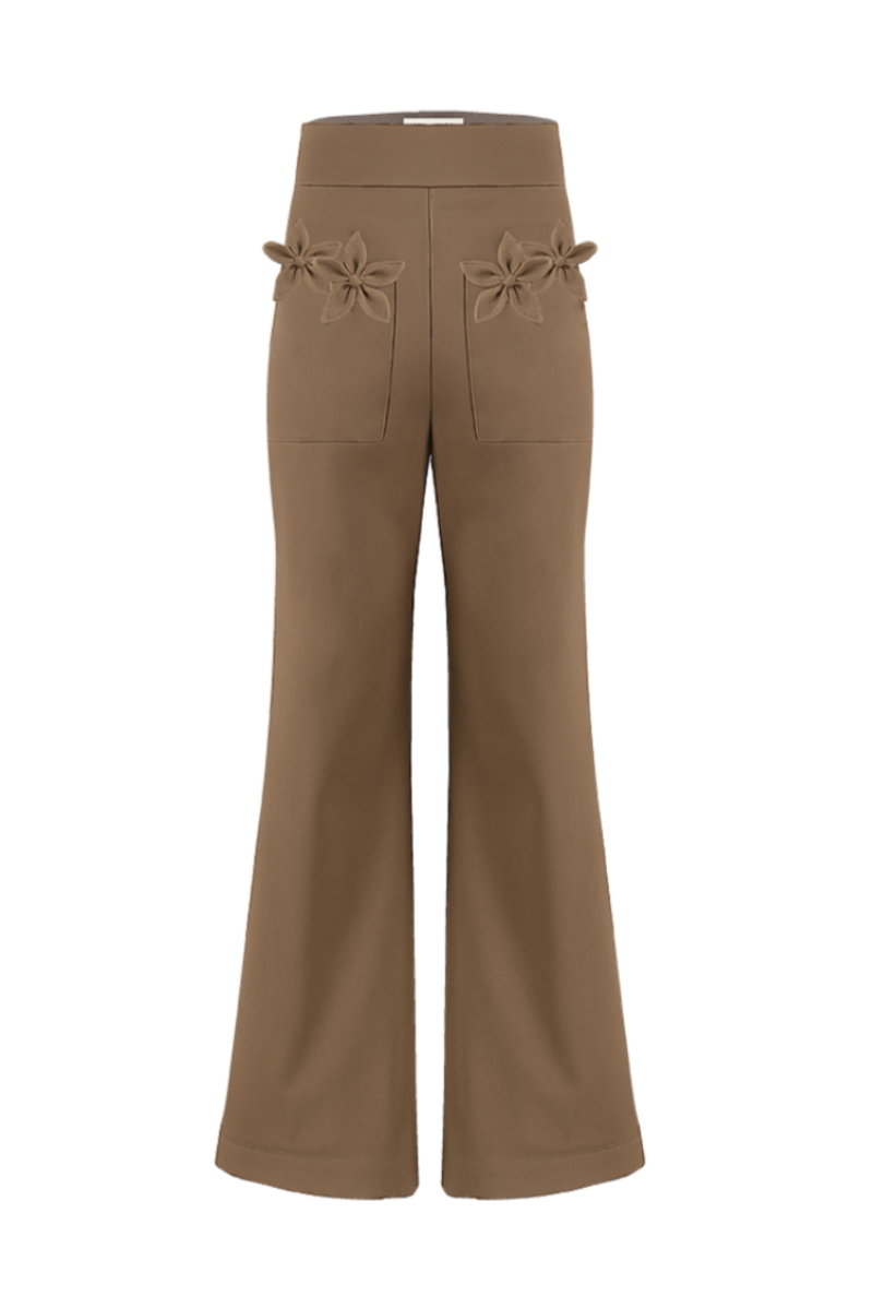 Tan floral pants by Ana + Maria featuring a vibrant floral pattern and relaxed fit, shown on a model.