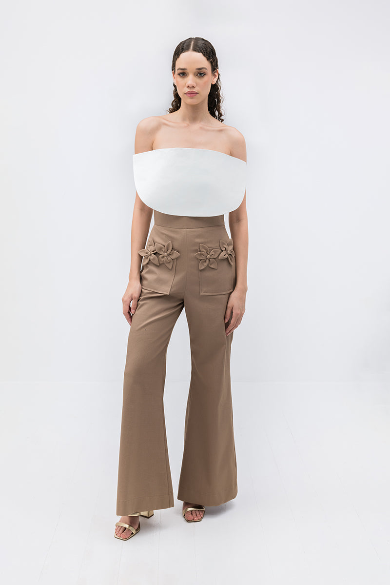 Tan floral pants by ANA + MARIA featuring a high-waisted design and vibrant floral pattern.
