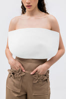 Tan floral pants by ANA + MARIA featuring a high-waisted design and vibrant floral pattern, shown on a model.