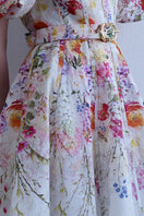 AISA Florelle midi dress with a floral pattern, featuring a fitted waist and flowing skirt, perfect for elegant summer occasions.