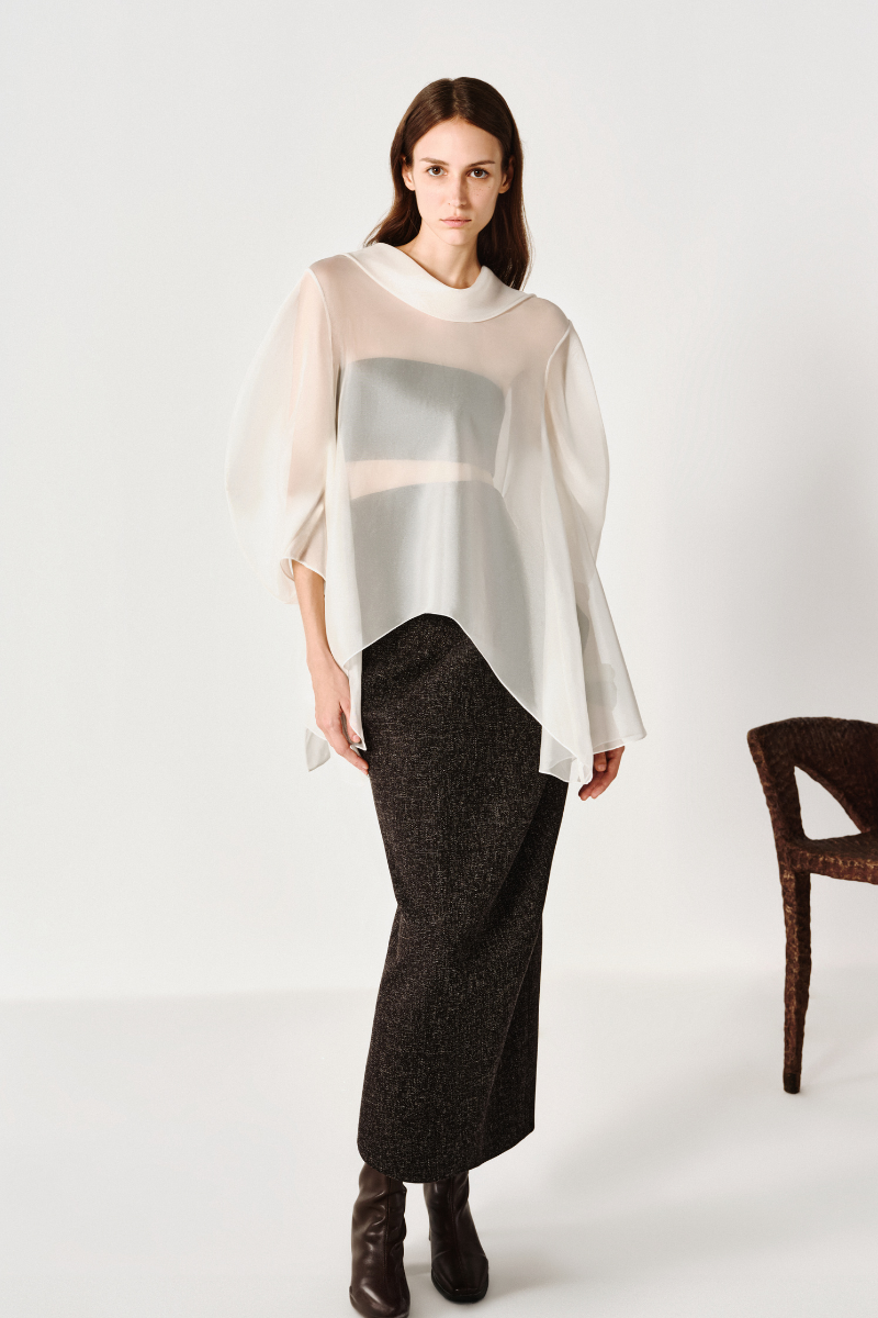 Light blue flowing draped shirt by Leica with soft fabric and relaxed fit, shown on a hanger against a plain background.