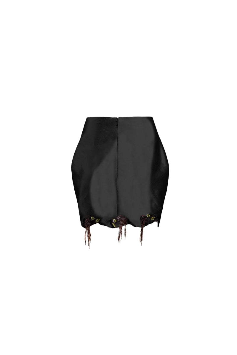 Black fold mini skirt by Yassmin Saleh, showing the stylish folded design and fitted silhouette on a model.