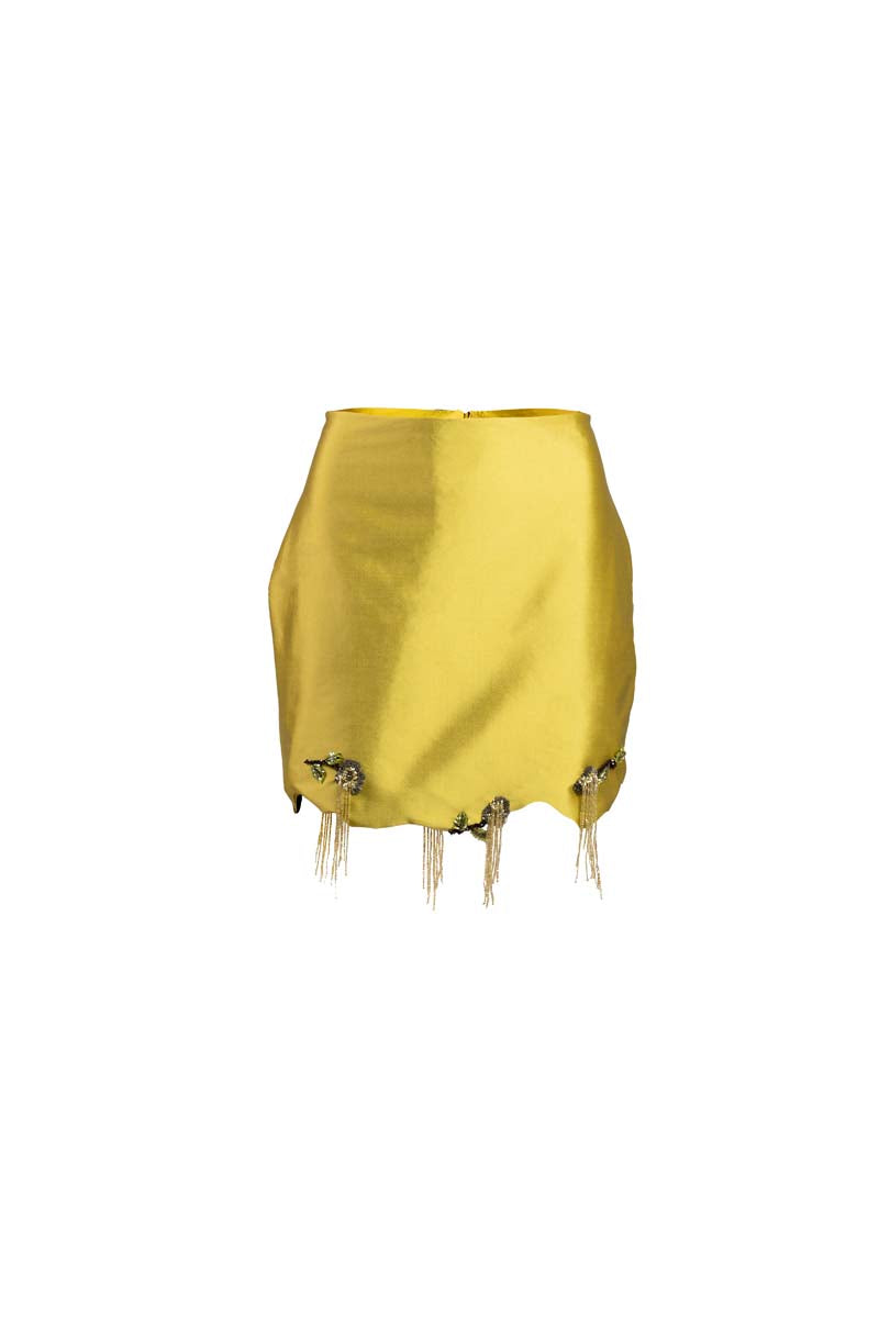 Green fold mini skirt by YASSMIN SALEH with a ghost front detail, displayed folded on a plain background.