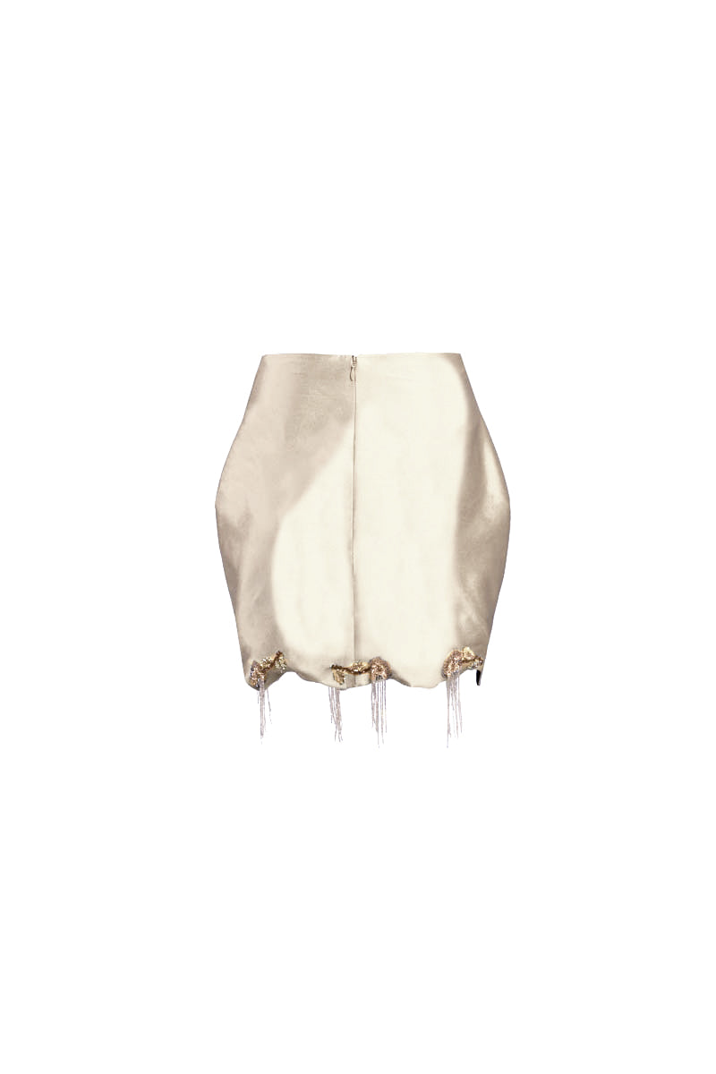 White fold mini skirt by Yassmin Saleh, shown with a stylish folded design and ghost back detail.