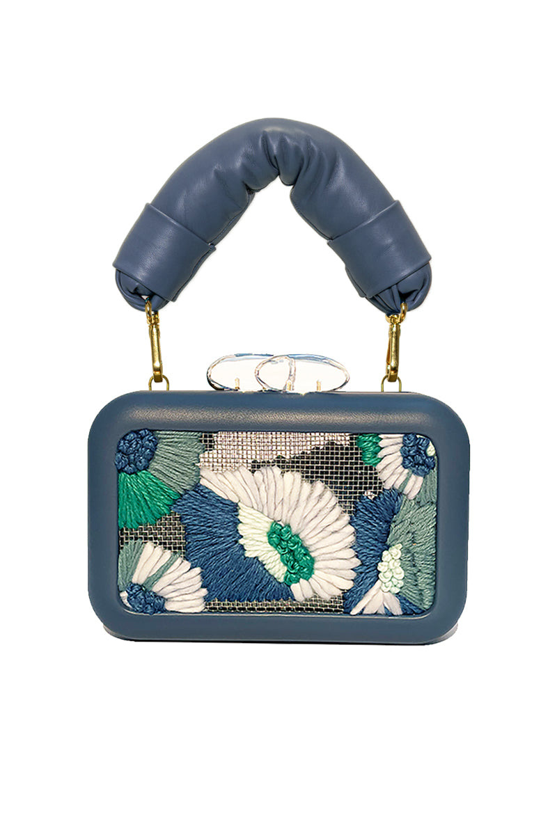 Sy&Vie Folhata Flora Grid Blue clutch with floral pattern, featuring a sleek design and compact size for elegant occasions.