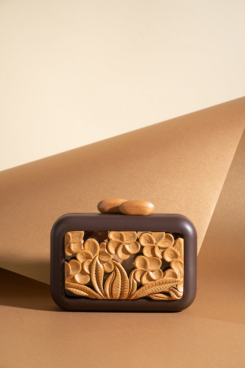 Brown acrylic clutch with hibiscus design by Sy&Vie, featuring a sleek, modern style and compact size for everyday or evening use.