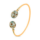 Green Sopo Milagro bangle bracelet by Álvaro Ávila featuring intricate design and polished gold finish.
