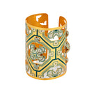 Green Fortuna cuff bracelet by Álvaro Ávila featuring a detailed oracle design on a sleek metal band.