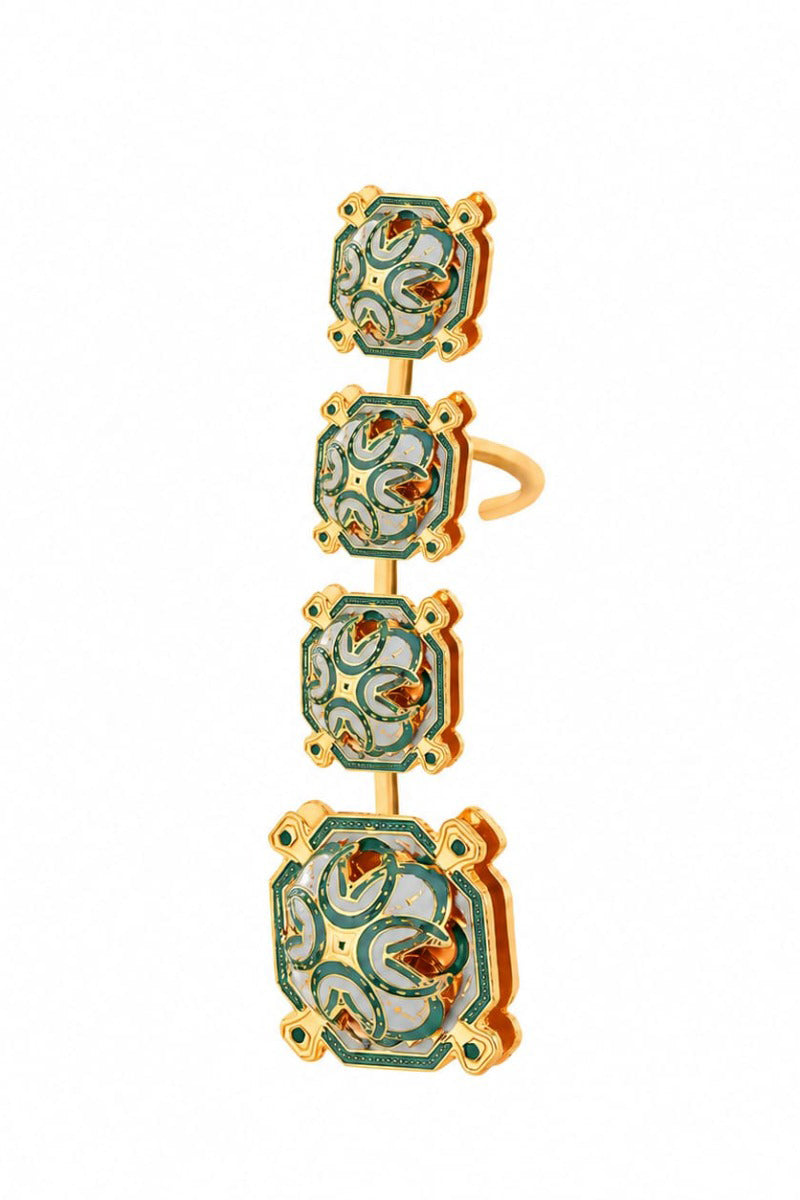 Green talisman ear cuff by Álvaro Ávila featuring intricate design and decorative elements on a model's ear.