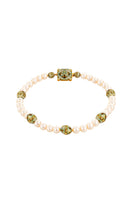Álvaro Ávila Sortilegio necklace with green Sopo beads, featuring intricate design, displayed on a neutral background.