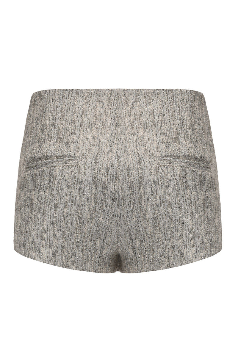 Back view of Nana Jacqueline Francesca mini skirt showing its fitted design and stylish silhouette.