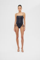 Shiny black FREY one-piece swimsuit by Maliluha displayed on a mannequin, featuring a sleek, fitted design for swimwear fashion.