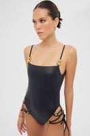 Shiny black Frey one-piece swimsuit by Maliluha displayed on a mannequin, featuring a sleek, fitted design for women.