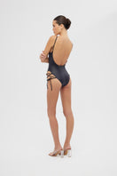 Shiny black FREY one-piece swimsuit by Maliluha displayed on a model, featuring sleek design and classic swimwear style.