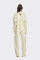 Ivory white long sleeve top with fringe details from Stolen Stores, featuring a stylish and bohemian-inspired design.