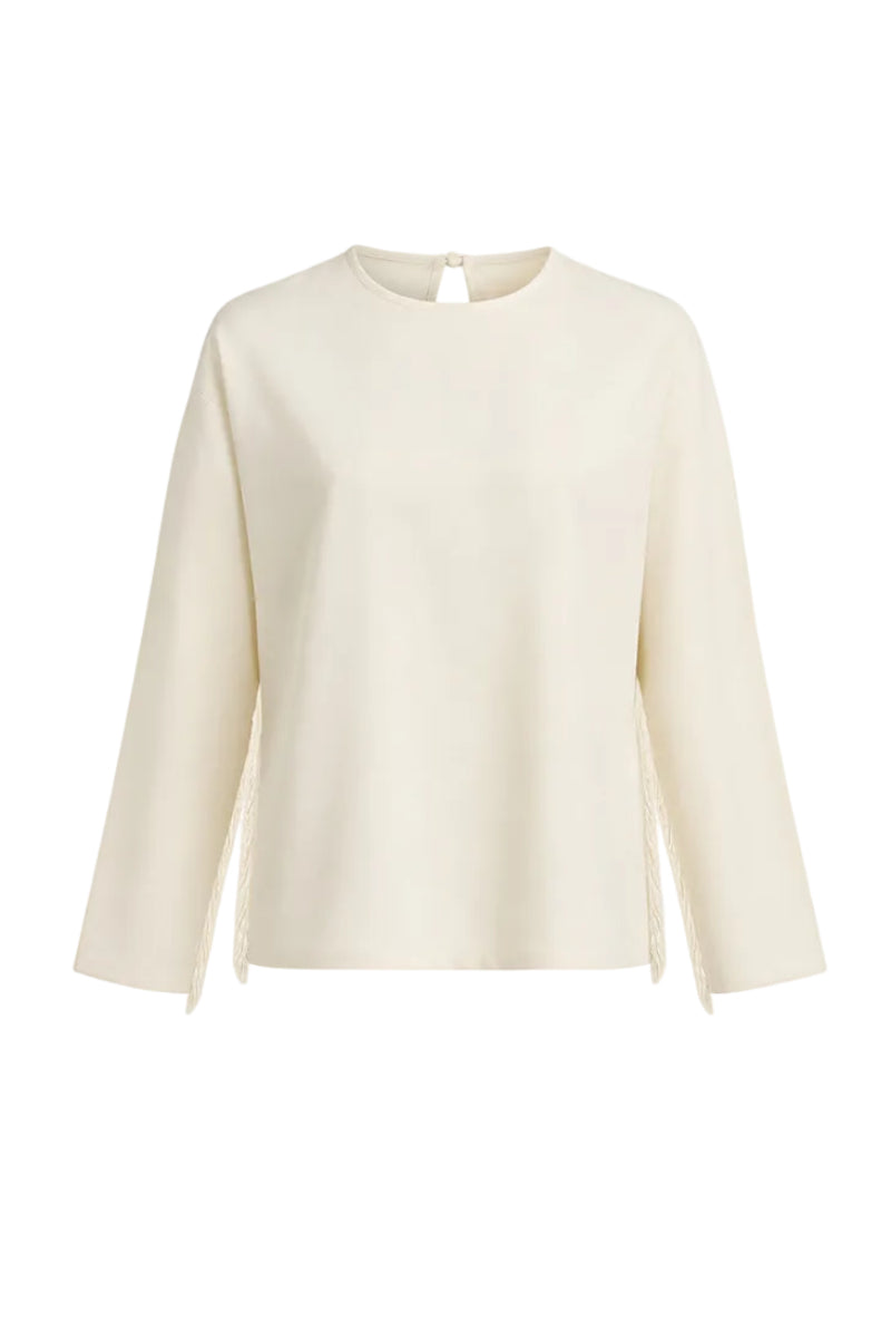 Ivory white long-sleeve top with fringe details from Stolen Stores, featuring a stylish and boho-chic design.